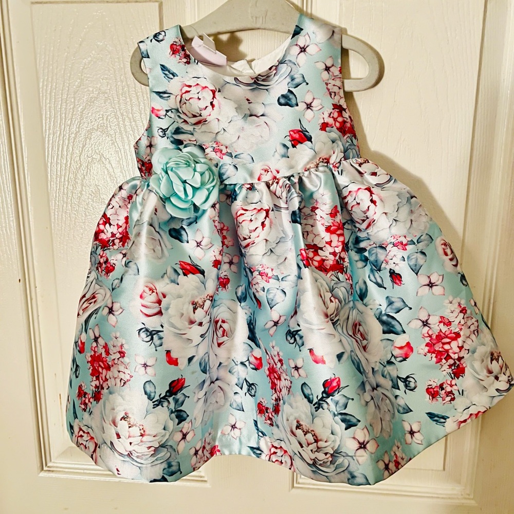 Beautiful floral detail, sleeveless satin fabrication, full skirt dress.